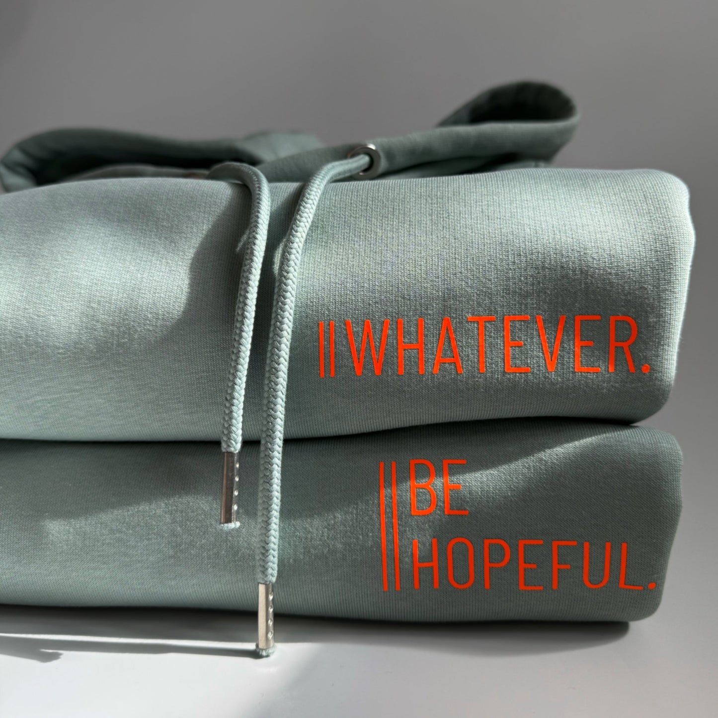 Hoodie Unisex 'Be hopeful.': Aloe / Neon Orange