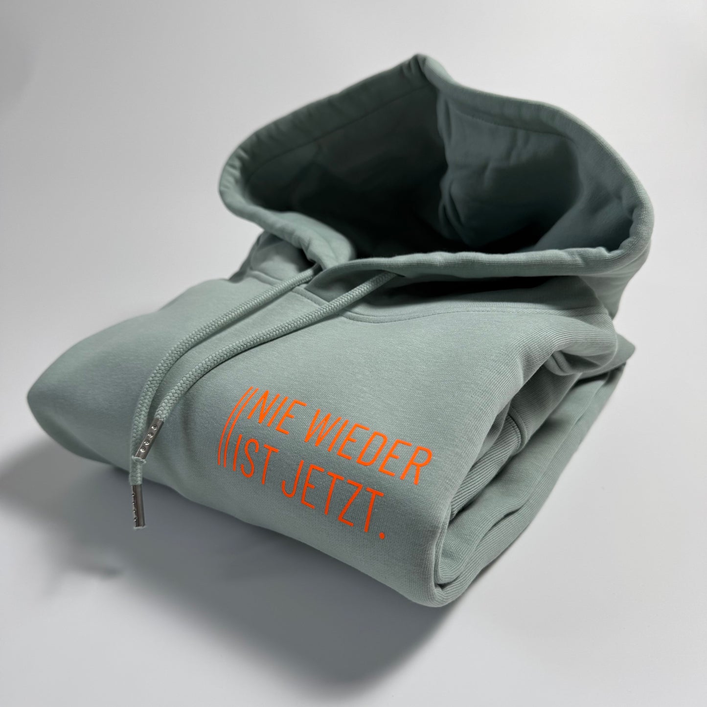 Hoodie Unisex 'Nie wieder ist jetzt.': Aloe / Neon Orange