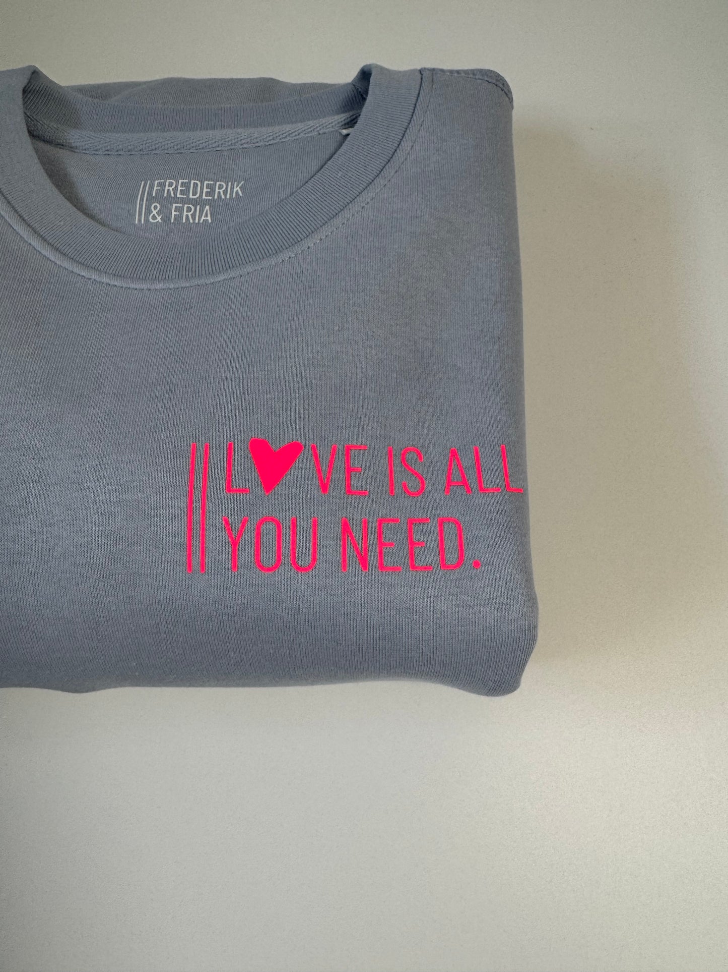 Sweatshirt Unisex 'Love is all you need.': Serene Blue / Neon Pink