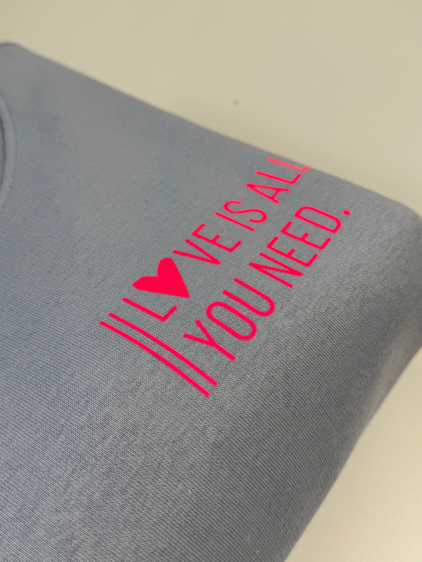 Sweatshirt Unisex 'Love is all you need.': Serene Blue / Neon Pink